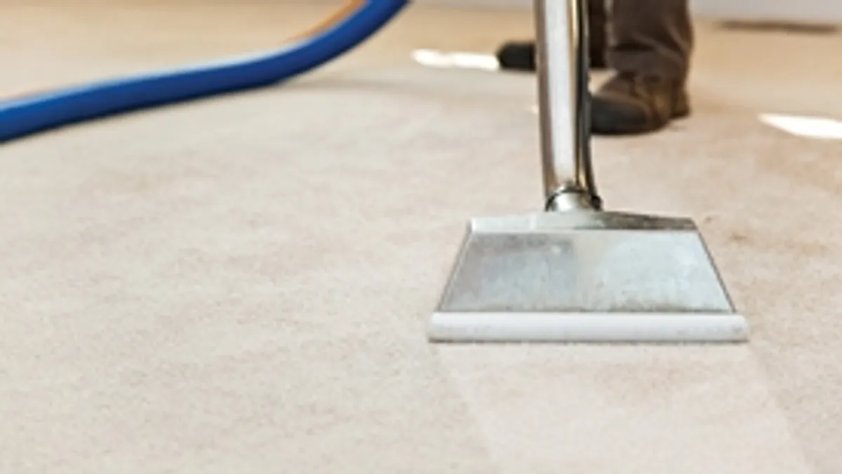 Carpet cleaning wand head gliding over a light carpet during hot-water extraction, San Francisco, CA.